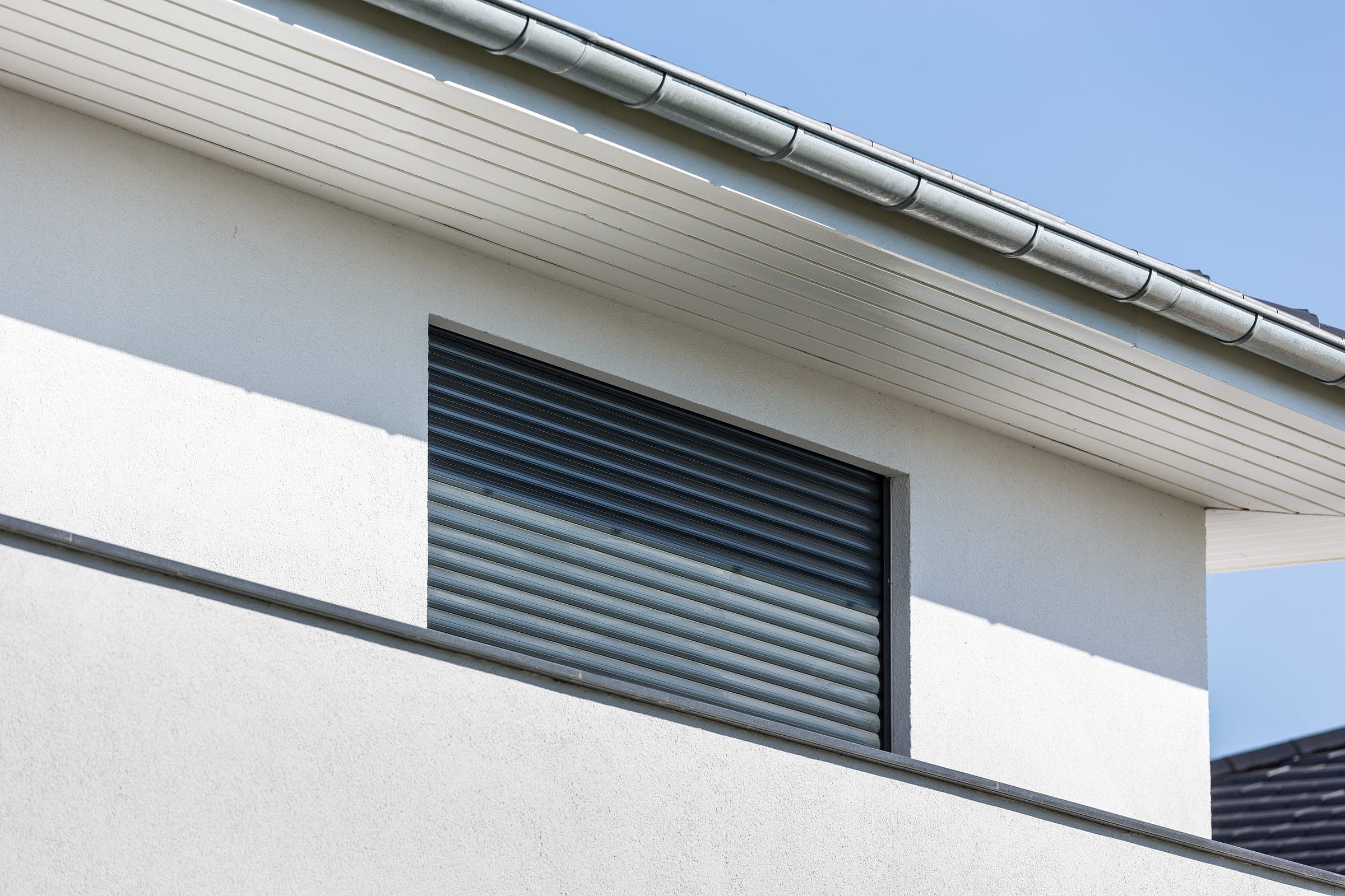 Vue détaillée d’un volet roulant monobloc Alulux Enext sur une fenêtre neuve
